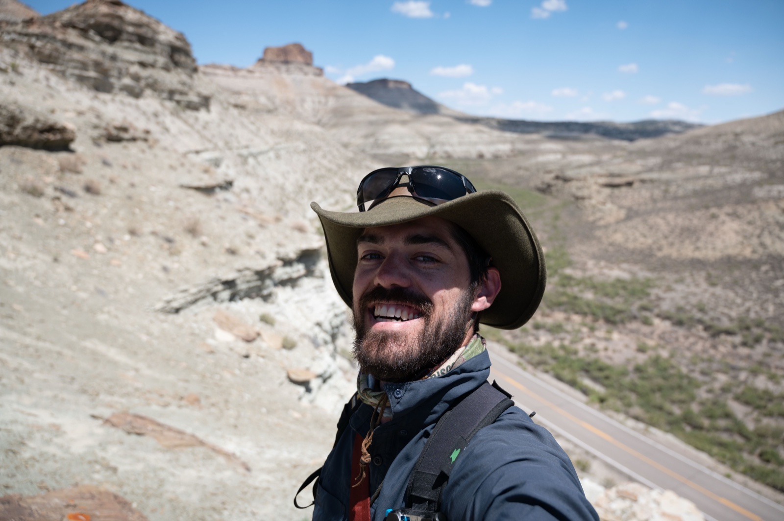 Ethan Parrish smiling in the field in the Wyoming badlands